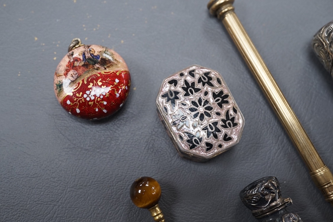 A 19th century Viennese gilt white metal and enamel circular vinaigrette, makers mark J.i.G, diameter 29mm, together with two late 19th century silver mounted senet bottles, a white metal and enamel pill box, a propellin